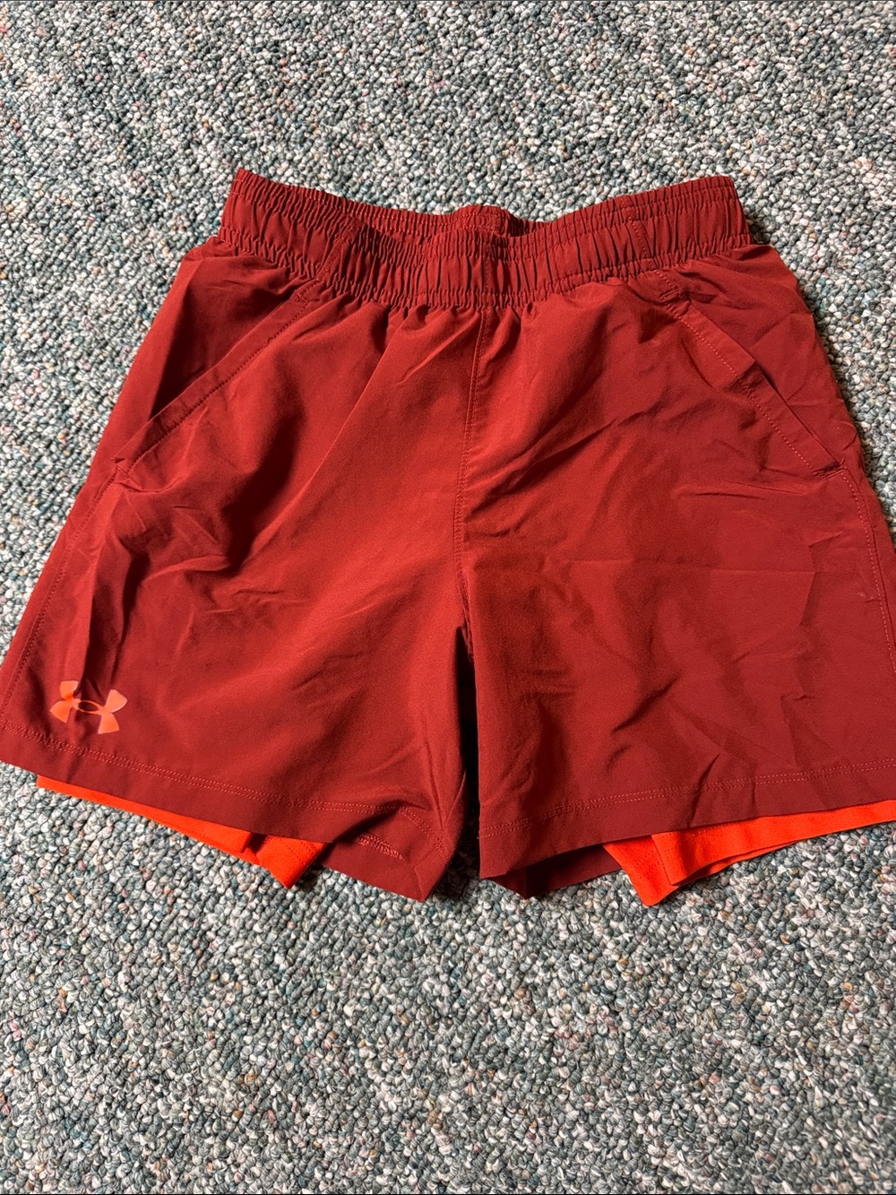 Under Armour Boyโs Burgundy Athletic Shorts with Orange Liner